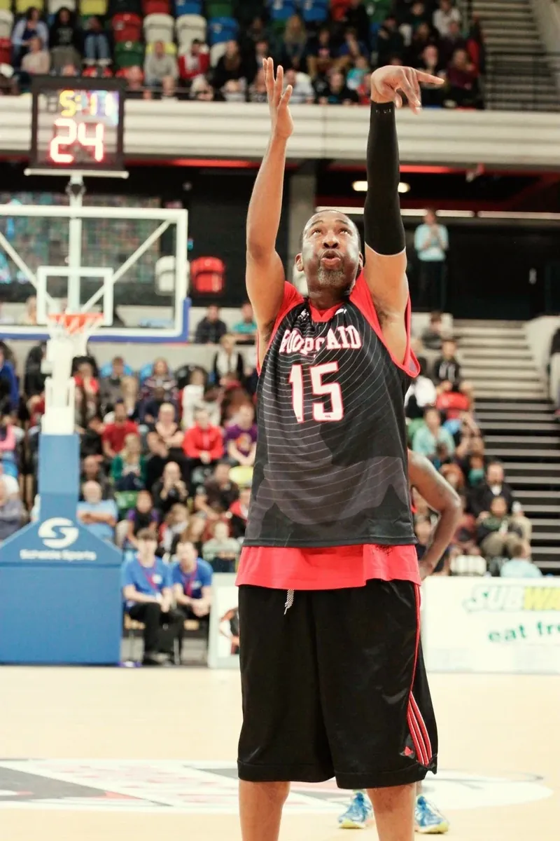 Cory McGee playing professional basketball in a packed arena